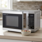 A SHARP SMC1162KSC microwave sitting on a beige laminate countertop next to a bowl of oatmeal.