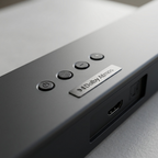 A macro view of the soundbar, featuring detailed power, volume, and input buttons, along with visible HDMI and optical ports.