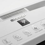 Detail close-up of sharp air purifier control panel with Plasmacluster indicator and SHARP logo.